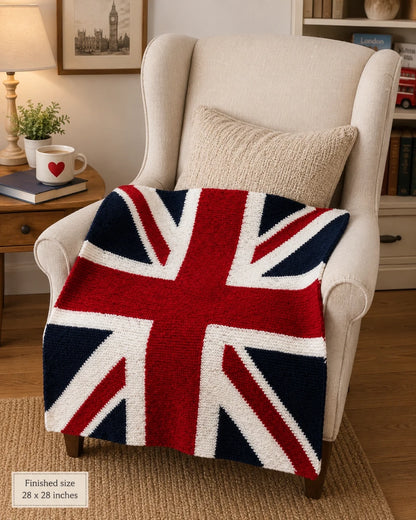 Union Jack Flag Lap Blanket knitting pattern draped over a reading chair in a cosy living room, showing the finished 28 x 28 inch British flag blanket.