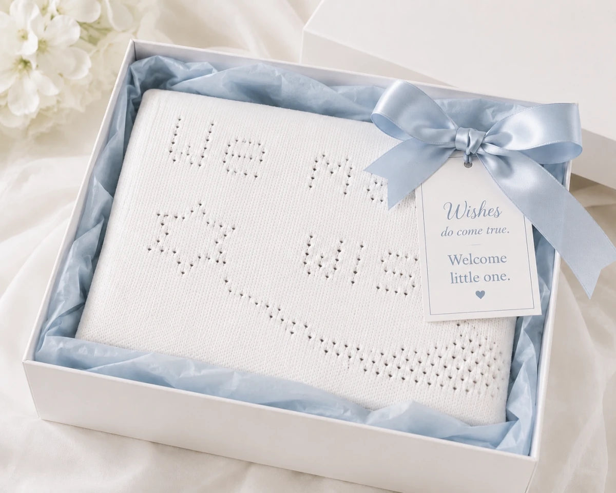 We Made a Wish baby blanket knitting pattern presented in a luxury white gift box with blue ribbon and welcome little one gift tag