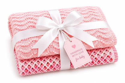 Gift wrapped Wiggly Curves and Gentle Waves baby blanket knitting pattern bundle with white satin ribbon and pink tag on a soft white background.