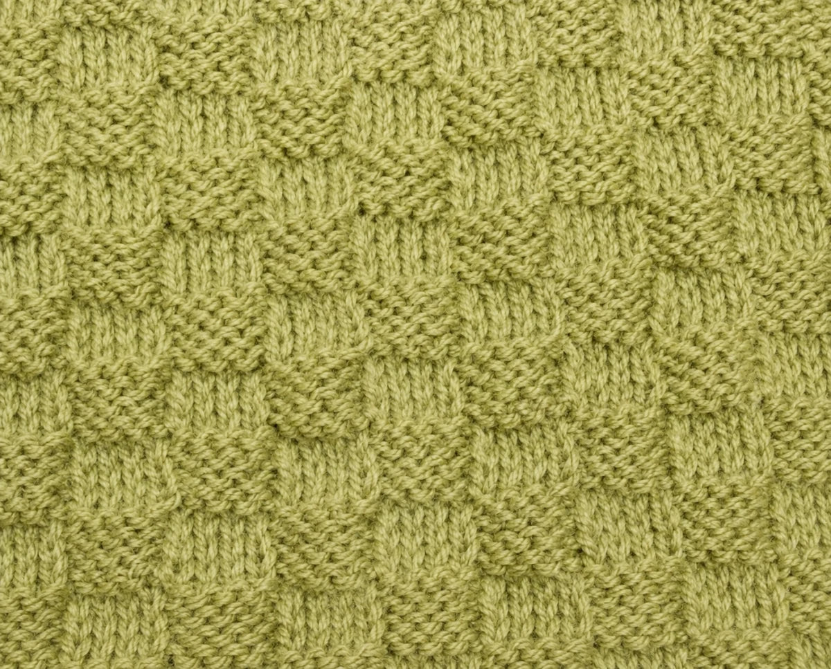 Close-up of the textured green border panels from the You Are My Sunshine baby blanket knitting pattern