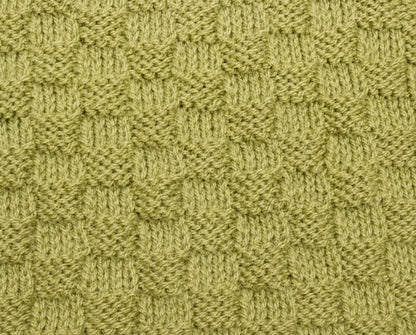 Close-up of the textured green border panels from the You Are My Sunshine baby blanket knitting pattern