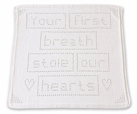 Your First Breath Stole Our Hearts baby blanket knitting pattern with lace lettering and heart details on a white background